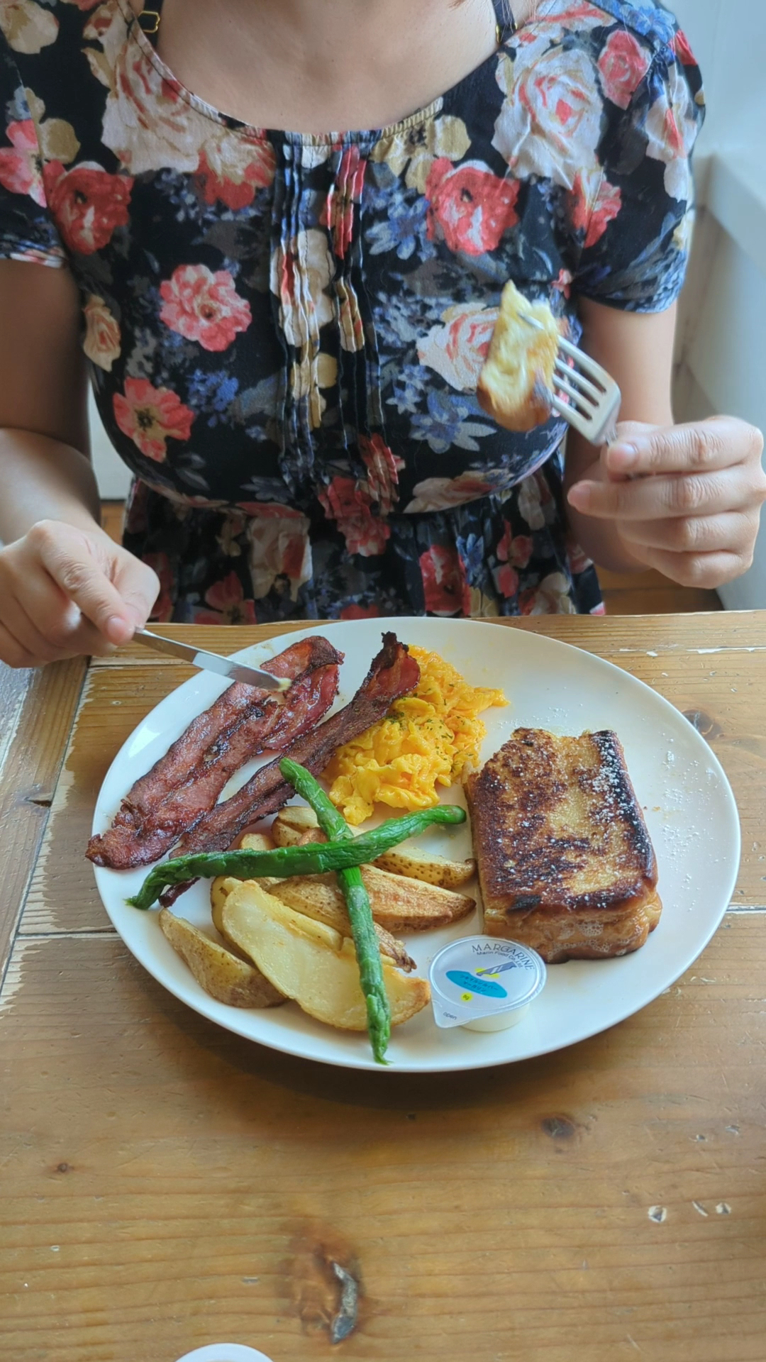 French toast with bacon, scrambled eggs, potatoes, and asparagus